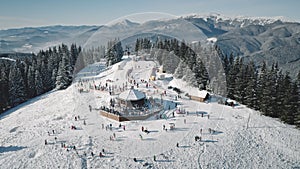 Winter sport resort with ski slope aerial. Snow mountain nature landscape. Tourists extreme sport