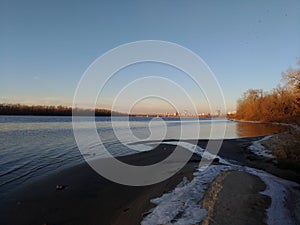 Winter - spring panorama of river with reflections