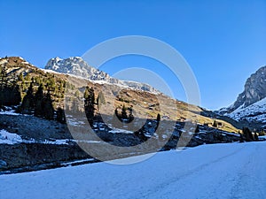 Winter Spring in Partnun near Sant Antonien in Praettigau. Hiking and skiing together. View of the peak Sulzfluh. Skimo