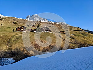 Winter Spring in Partnun near Sant Antonien in Praettigau. Hiking and skiing together. View of the peak Sulzfluh. Skimo