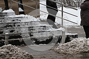 Winter. Stairs. People walk on a very snowy stairs to the underpass. People step on an icy stairs, slippery stairs