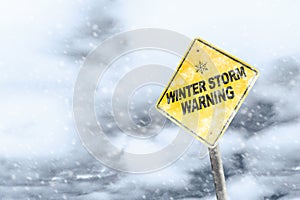 Winter Storm Warning Sign With Snowfall and Stormy Background photo