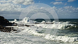 Winter storm waves crashing over roack sea spray