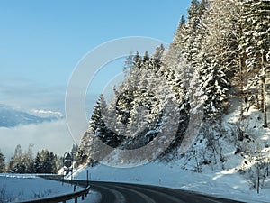 Winter street at early morning in Austrian mountains.
