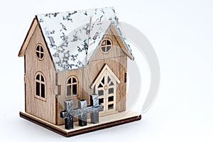 Winter style model wooden house with snow on roof