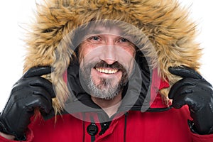 Winter stylish menswear. Man bearded hipster wear warm jacket with fur white background. Guy wear warm jacket with hood