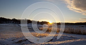 Winter sun rising over agriculture landscape