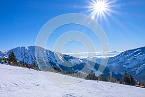 Winter Sunny Day Over Mountain Peaks and Ski Slope