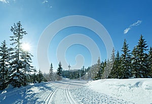 Winter sunny mountain landscape with ski run.