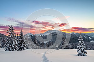 Winter. Sunrise. A panoramic view of the covered with snowy mountain peak. Natural landscape with beautiful sky. Location place