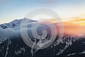 Winter. Sunrise. A panoramic view of the covered with snowy mountain peak. Natural landscape with beautiful sky. Location place