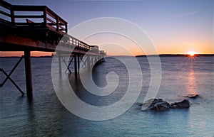 Winter sunrise on a pier photo