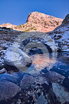 Winter sunrise on Przedni Staw Polski in High Tatras photo