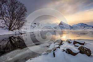 Winter Sunrise with sun reflection on water