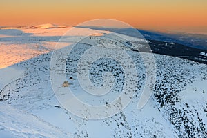Winter, sunrise time, view from Snezka to Silesian house, krkonose mountains. Snezka is mountain on the border between Czech