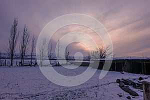 Winter sunset on a humble farmhouse photo