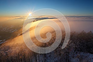 Winter sunset over the clouds
