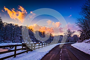 Winter sunset over a fence and country road in rural York County