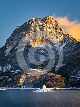 Winter sunset view of the Grand Morgon mountain rising above the Saint Michel Bay of Serre Poncon lake, Southern Alps, France