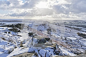 Winter sunshine on a snow covered Curbar Edge in Derbyshire