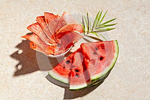 Winter supplies: slices of dried watermelon with fresh pieces on light background with deep shadow