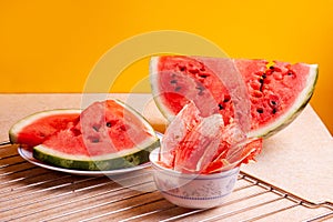 Winter supplies: slices of dried watermelon with fresh pieces on yellow background