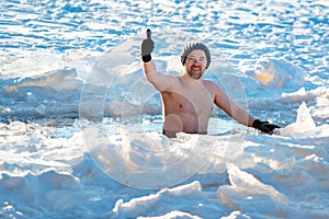 Winter swimming. Brave man in an ice-hole