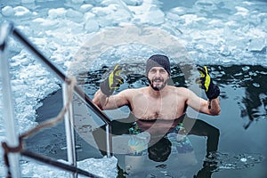 Winter swimming. Man in an ice-hole.