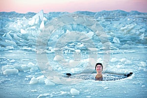 Winter swimming. Man in an ice-hole