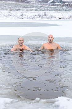 Winter swimming. Man in ice-hole