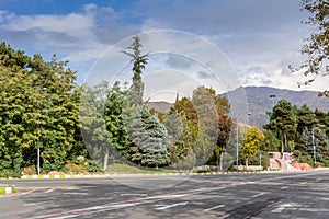 Winter Tehran street view in Tehran International Exhibition Center with snow covered Alborz Mountains against cloudy sky on