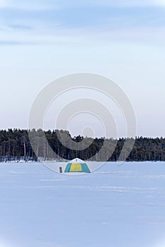 Winter tent on the lake for fishing. winter sports vertical photo