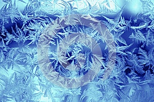 Winter texture of frost on the glass window as a background