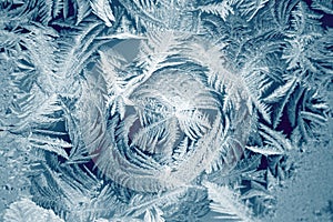 Winter texture of frost on the glass window as a background