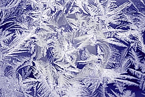 Winter texture of frost on the glass window as a background