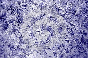 Winter texture of frost on the glass window as a background