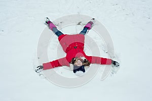 Winter time,cheerful girl having fun in the snow, top view