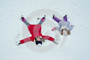 Winter time, children having fun in the snow, top view
