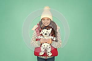 Winter time fun. child happy to play with toy. kid toy shop. small girl hold dog toy. kid love her fluffy pet puppy