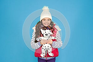 Winter time fun. child happy to play with toy. kid toy shop. small girl hold dog toy. kid love her fluffy pet puppy