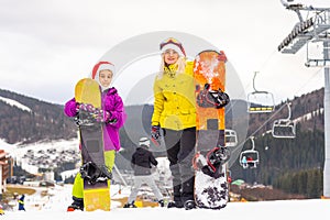 Winter time and skiing - family with ski and snowboard on ski ha