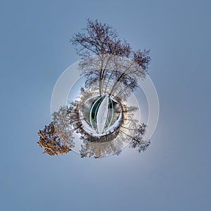 Winter tiny planet in snow covered forest on wooden bridge. transformation of spherical panorama 360 degrees. Spherical abstract