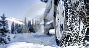 Winter tire. Detail of car tires in winter on the road covered with snow. Panorama  banner