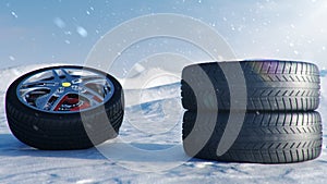 Winter tires on a background of snowstorm, snowfall and slippery winter road. Winter tires concept. Concept tyres