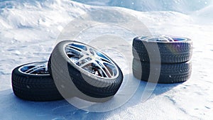 Winter tires on a background of snowstorm, snowfall and slippery winter road. Winter tires concept. Concept tyres