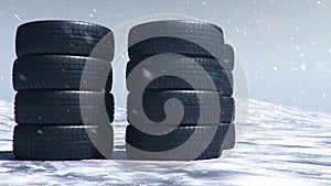 Winter tires on a background of snowstorm, snowfall and slippery winter road. Winter tires concept. Concept tyres