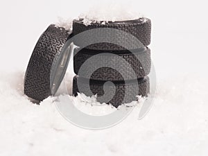 Winter tires stacked in the snow, winter season concept