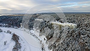 Winter top view of the winter forest and the valley with a bend of the river