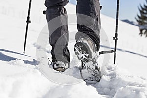Winter trekking with male boots in the snow