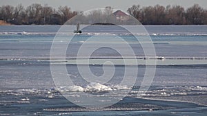 Winter, two men in a boat. Crossing in the winter on the river.